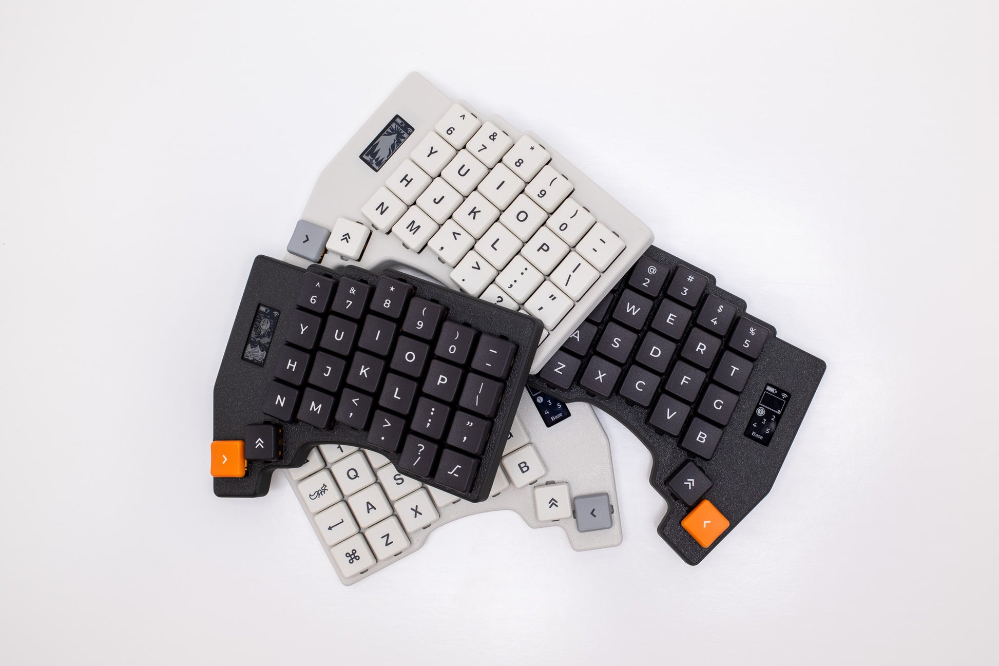 Mantaray Pro Wireless keyboards in black and white, arranged in a pile on a white background.