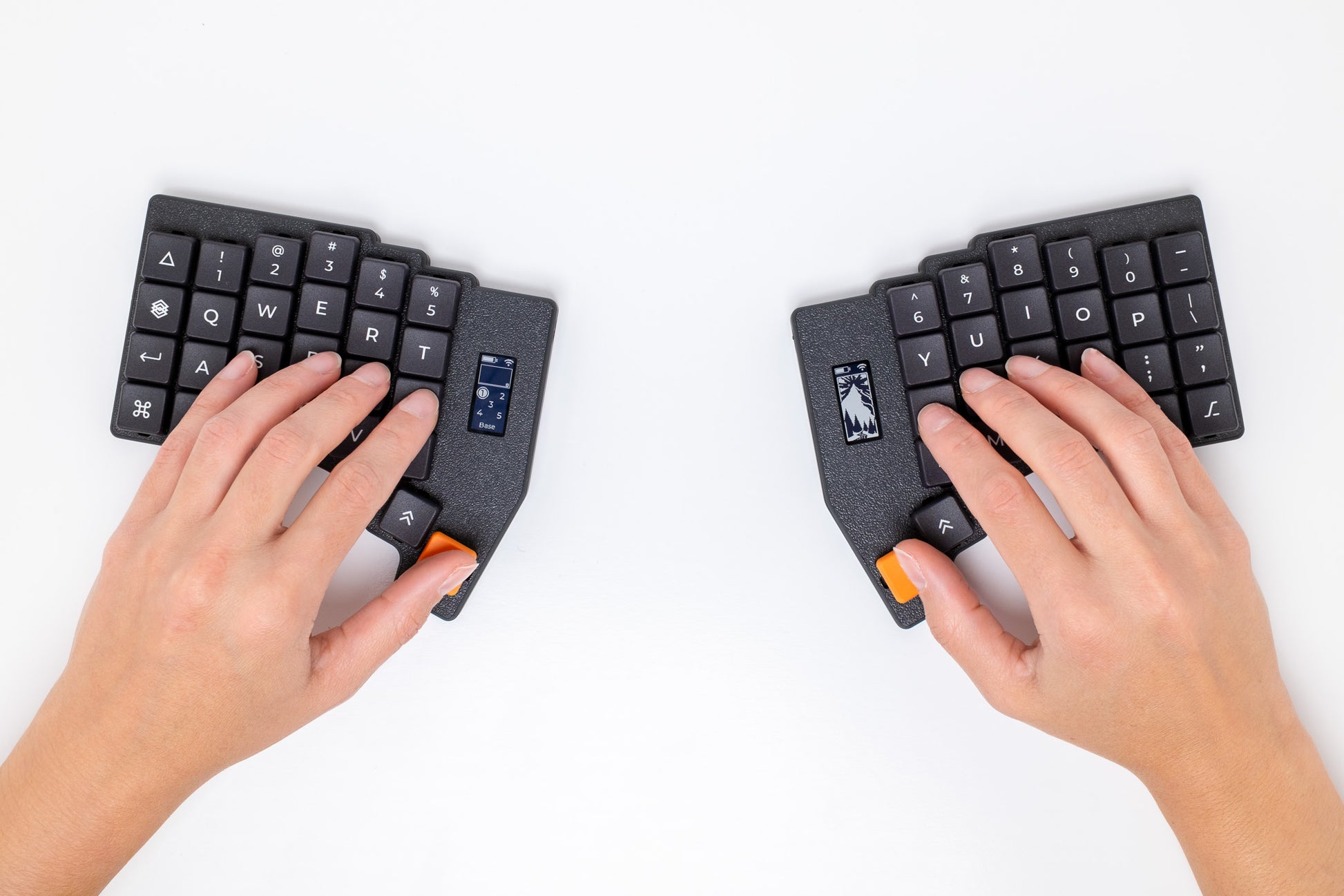 Two hands typing on the Mantaray Pro Wireless with a white background